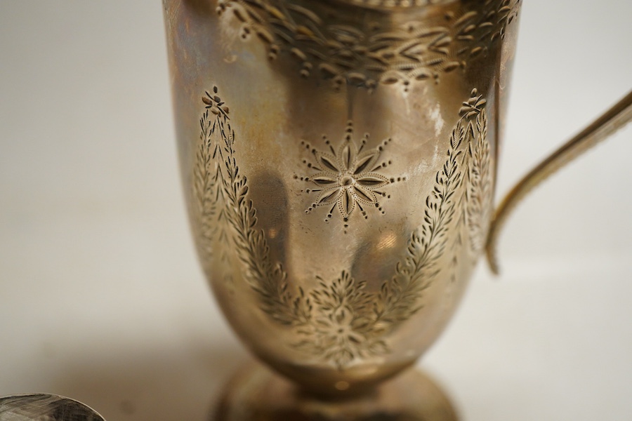A Victorian silver cream jug, London, 1874, Robert Harper, of helmet form with bright cut decoration, together with a small continental beaker and an Elizabeth II pin dish with feature hallmarks, weight approx 8.56ozt (3
